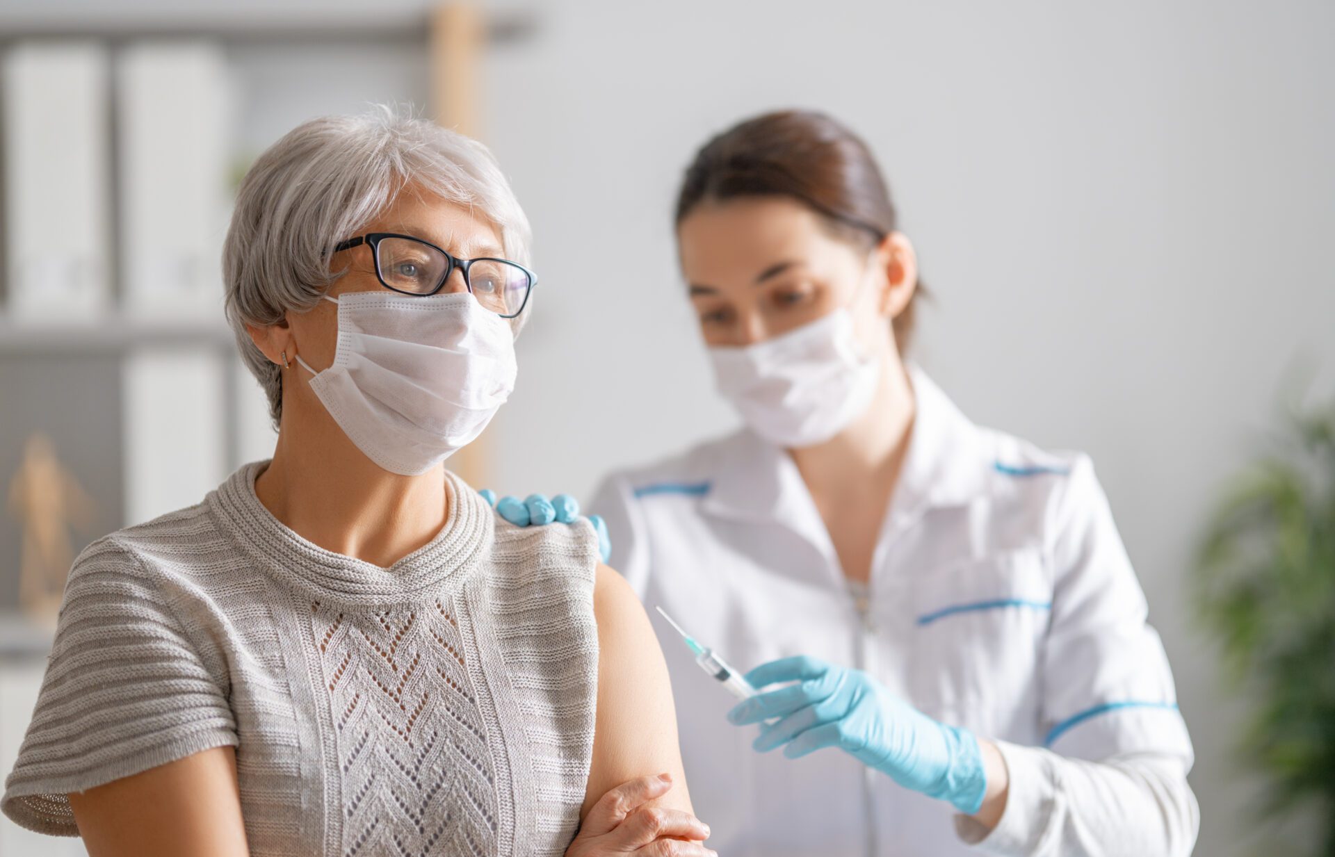 Doctor,Giving,A,Senior,Woman,A,Vaccination.,Virus,Protection.,Covid-2019.